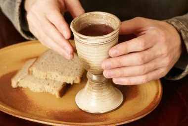 depositphotos 27251513 stock photo hands with chalice and bread